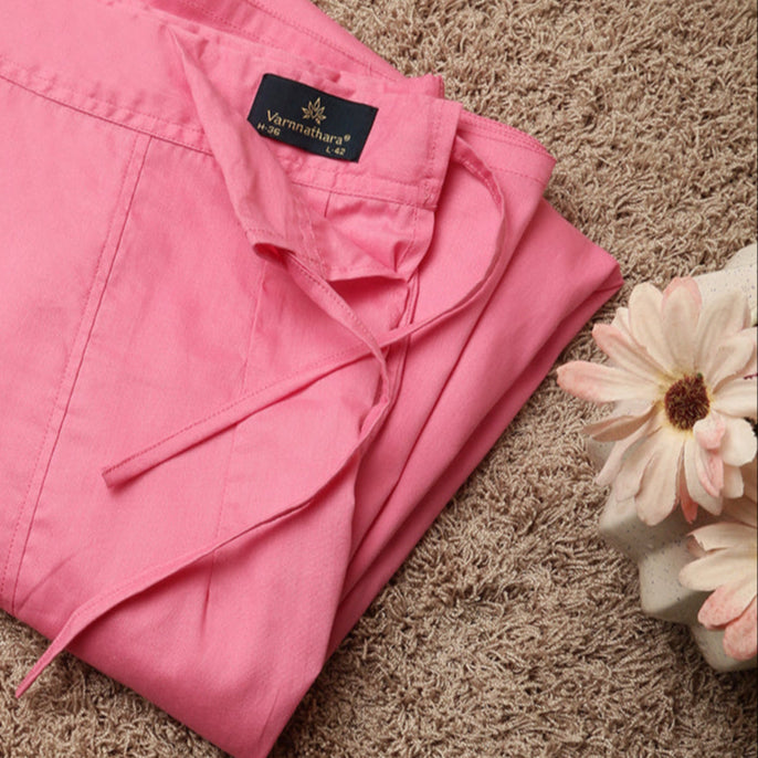 Folded pink petticoat inskirt  with a brand label on a brown surface with flowers on the side.